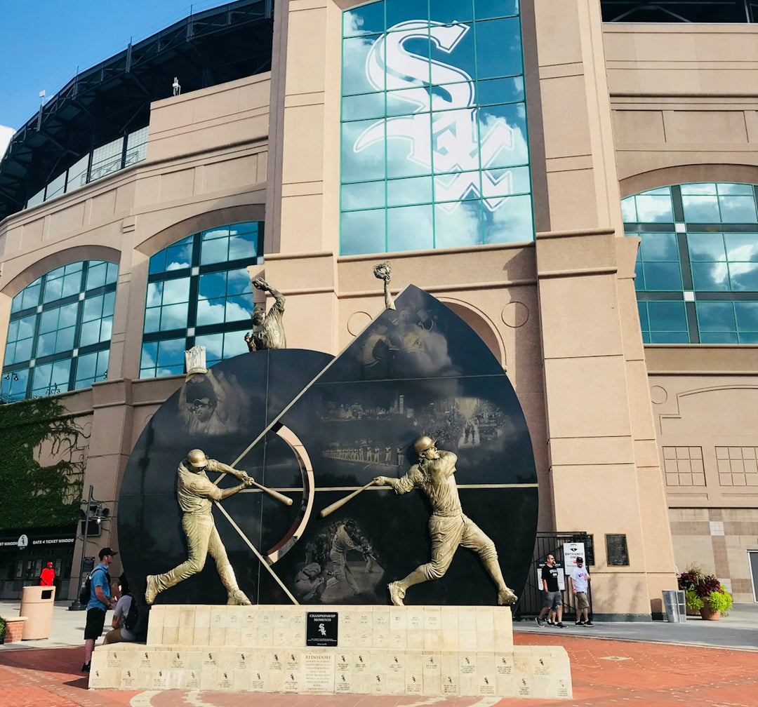 grey baseball statue near concrete building