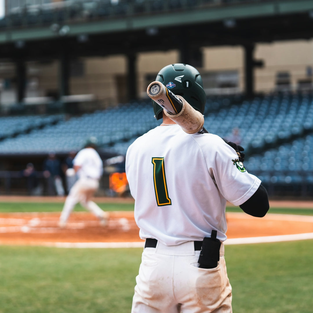 a baseball player holding a bat on top of a field