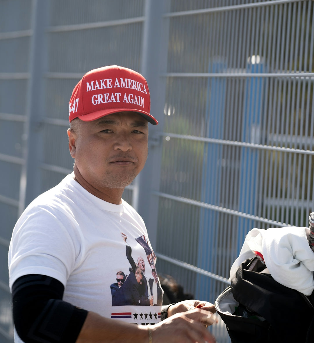 A man wearing a red hat and holding a golf club