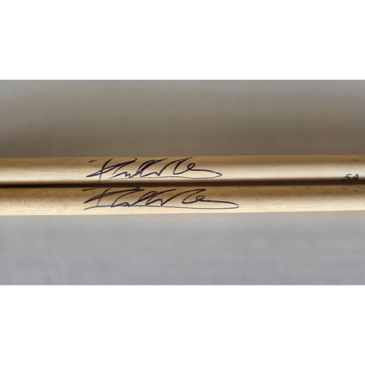 Phil Collins legendary drummer Genesis pair of drumsticks signed with proof.
