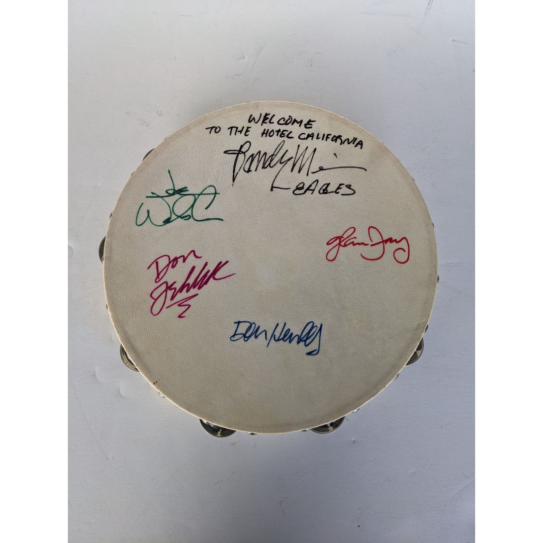 Eagles Don Henley, Don Felder, Glenn Frey, Joe Walsh, Randy Meisner with lyrics signed with proof 12" tambourine