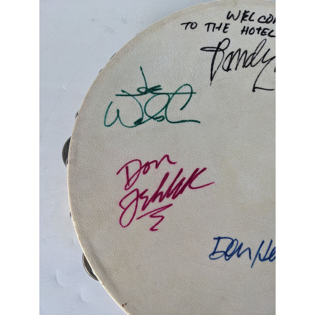 Eagles Don Henley, Don Felder, Glenn Frey, Joe Walsh, Randy Meisner with lyrics signed with proof 12" tambourine