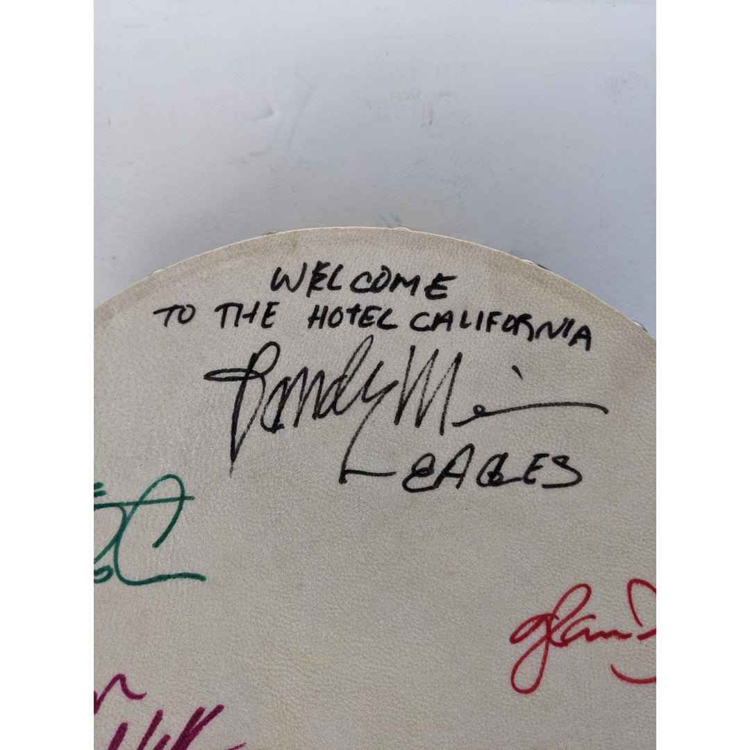 Eagles Don Henley, Don Felder, Glenn Frey, Joe Walsh, Randy Meisner with lyrics signed with proof 12" tambourine
