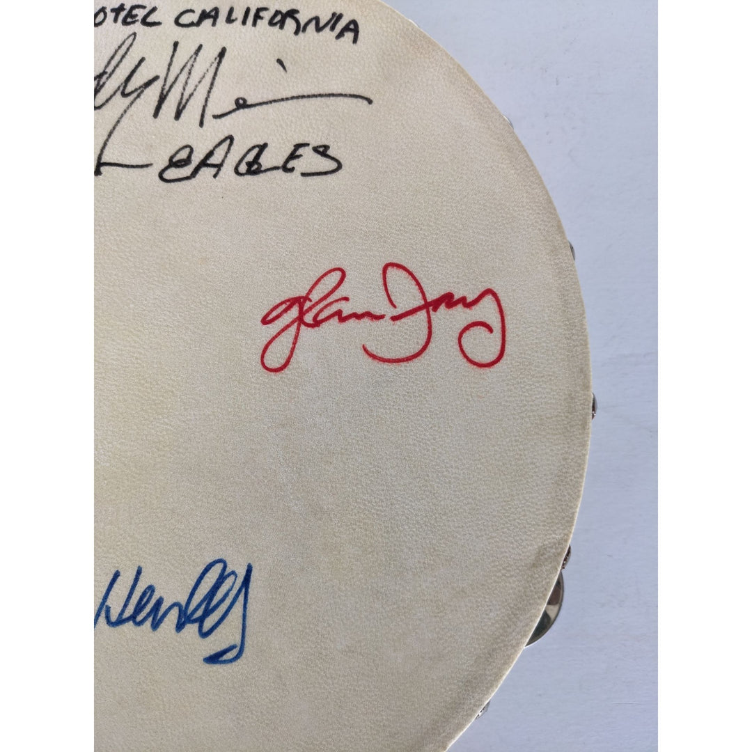 Eagles Don Henley, Don Felder, Glenn Frey, Joe Walsh, Randy Meisner with lyrics signed with proof 12" tambourine