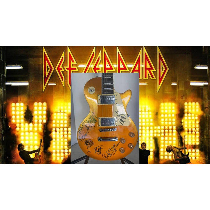 Def Leppard Phil Collen, Vivian Campbell, Joe Elliott, Rick Savage, Rick Allen. Gold Les Paul electric guitar signed with proof.