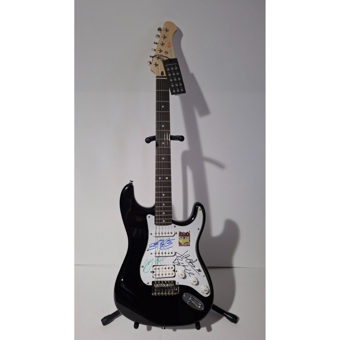 Eric Clapton, Ginger Baker, Jack Bruce, Cream, Fender Stratocaster electric guitar signed with proof