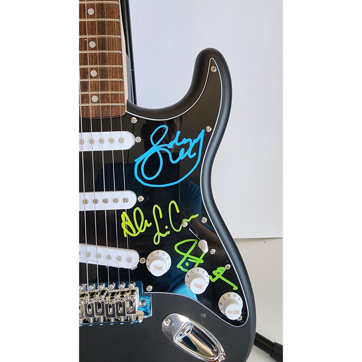 Rush Band signed Neil Peart, Geddy Lee, Alex Lifeson vintage black Fender Stratocaster full size electric guitar signed with proof