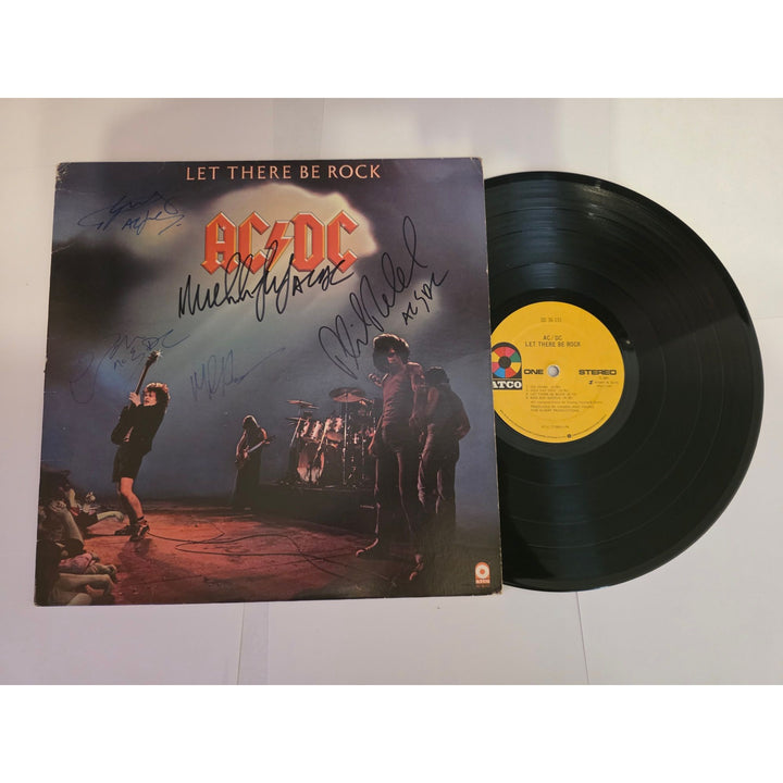 Angus young Malcolm Young Brian Johnson Cliff Williams Phil Rudd AC DC Let there be rock lp signed with proof.