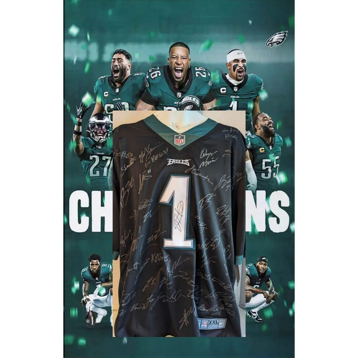 Autographed black football jersey over a green backdrop with players and the word "Champions."