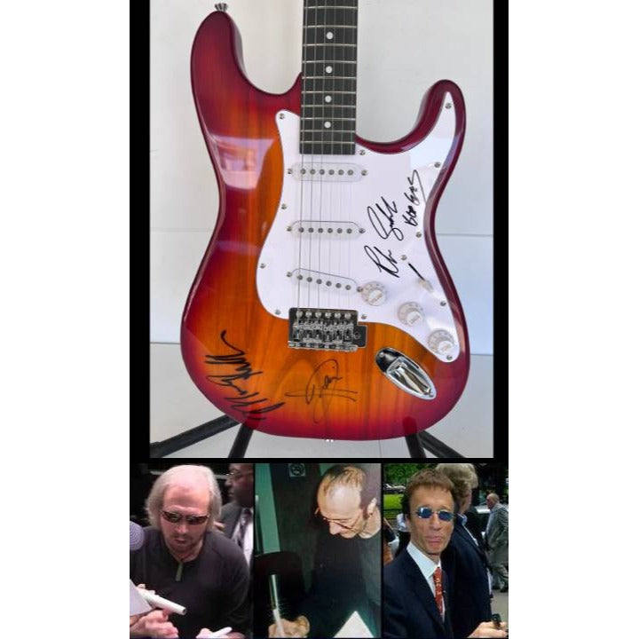 Barry, Robin and Maurice Gibb the Bee Gees electric guitar signed with proof.