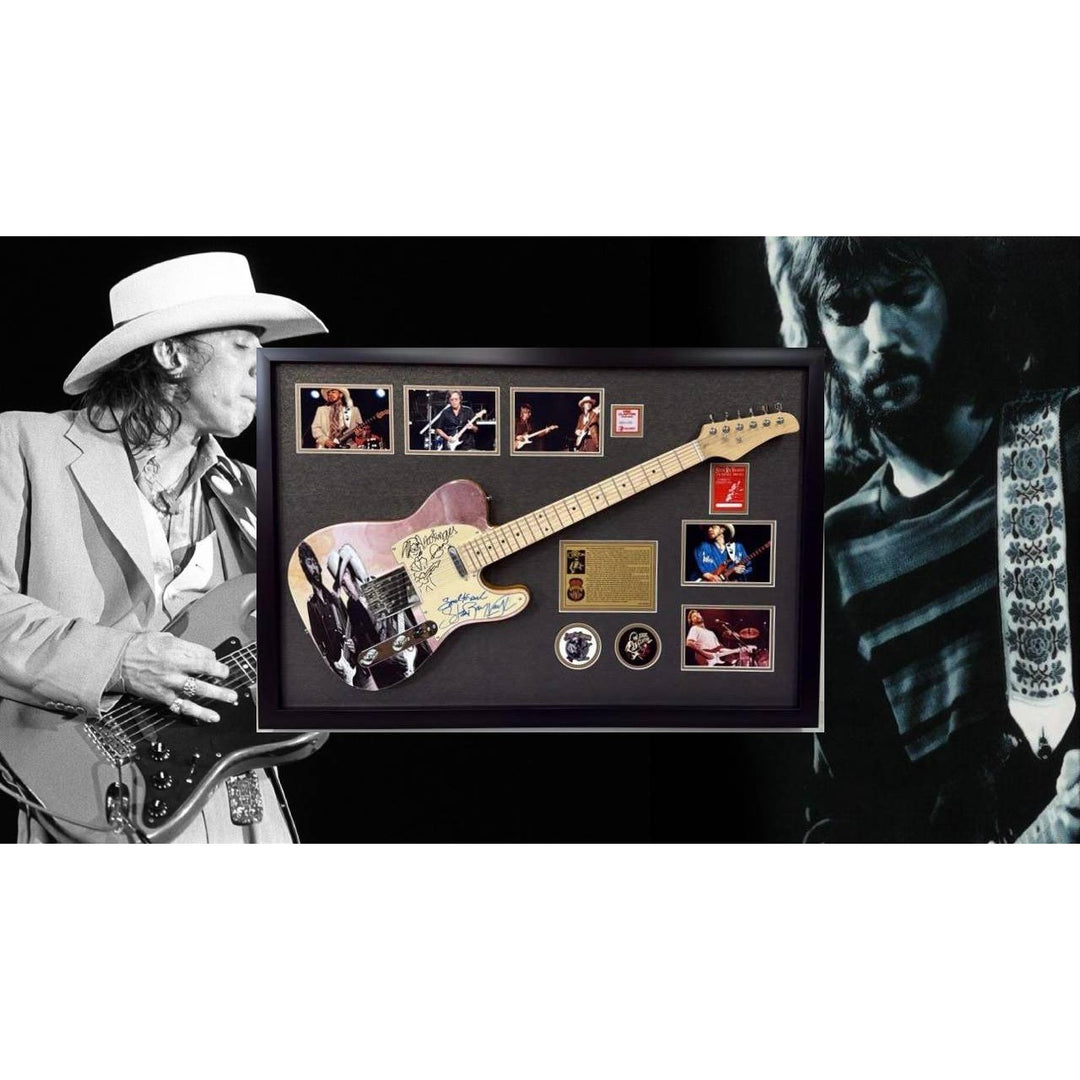 Eric Clapton and Stevie Ray Vaughan with hand made sketch and inscription from (Stevie) full size electric guitar signed and framed.