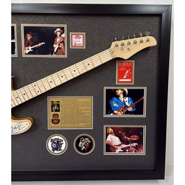Eric Clapton and Stevie Ray Vaughan with hand made sketch and inscription from (Stevie) full size electric guitar signed and framed.