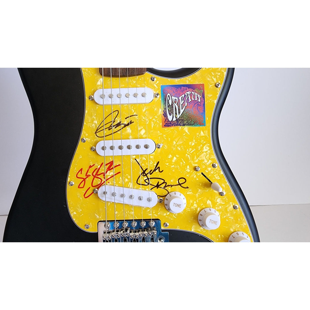 Eric Clapton, Ginger Baker, Jack Bruce, Cream, authentic Fender Stratocaster electric guitar signed with proof