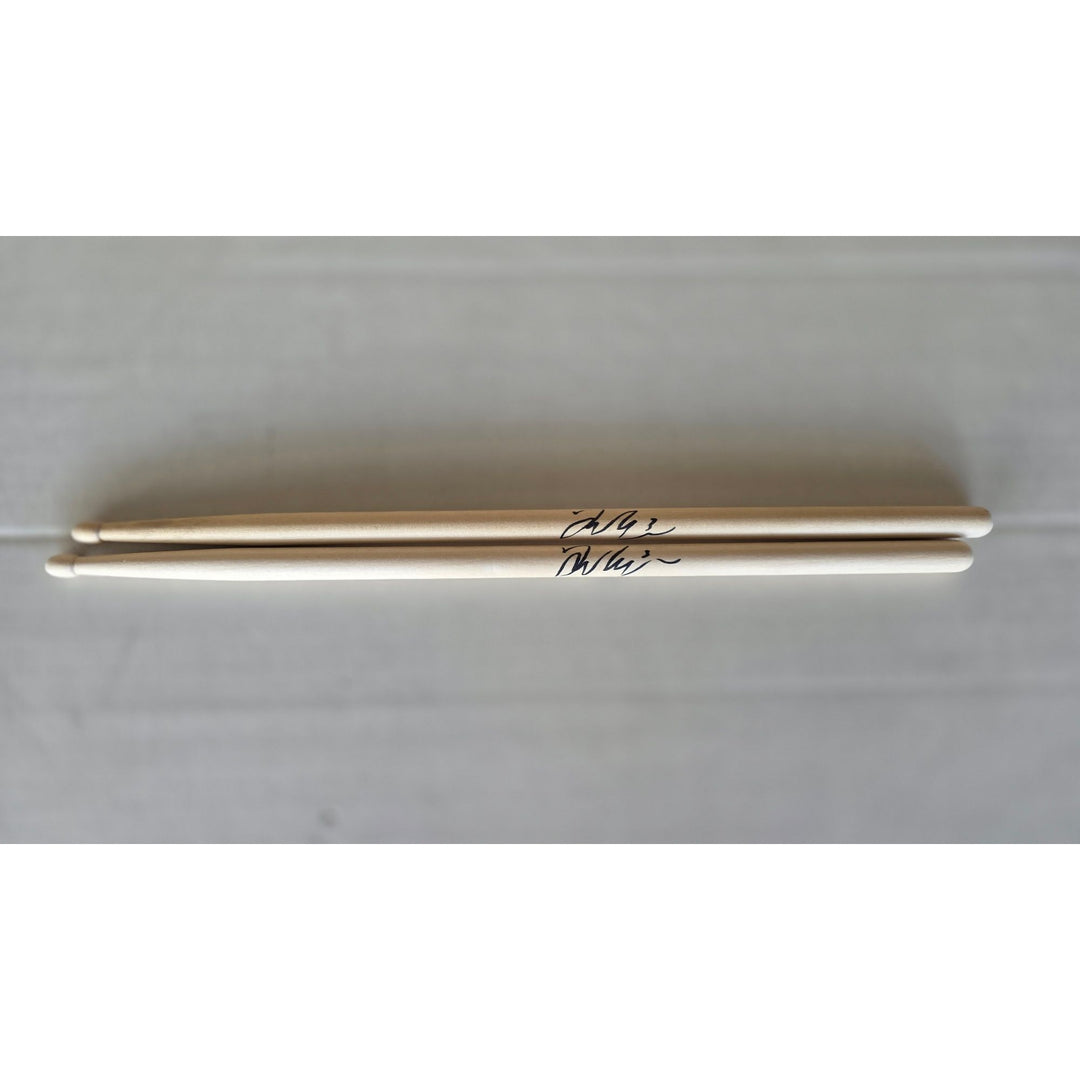 Taylor Hawkins Foo Fighters pair of drumsticks signed with proof.