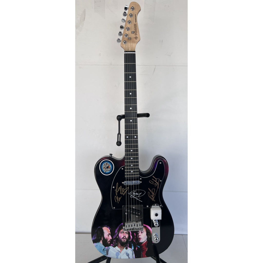 Barry, Robin and Maurice Gibb the Bee Gees  One of a Kind" telecaster full size electric guitar signed with proof.