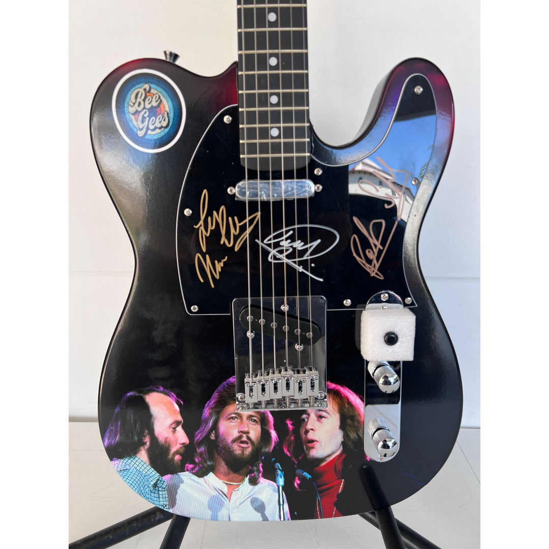 Barry, Robin and Maurice Gibb the Bee Gees  One of a Kind" telecaster full size electric guitar signed with proof.