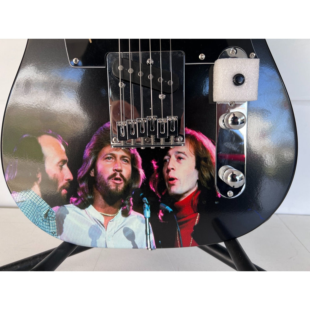 Barry, Robin and Maurice Gibb the Bee Gees  One of a Kind" telecaster full size electric guitar signed with proof.