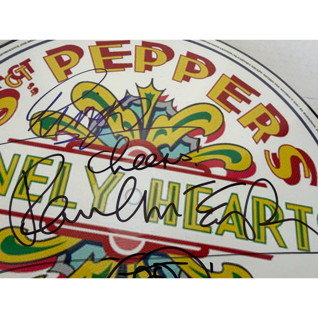 Paul McCartney Ringo Starr and Sir George Martin drumhead signed with proof.
