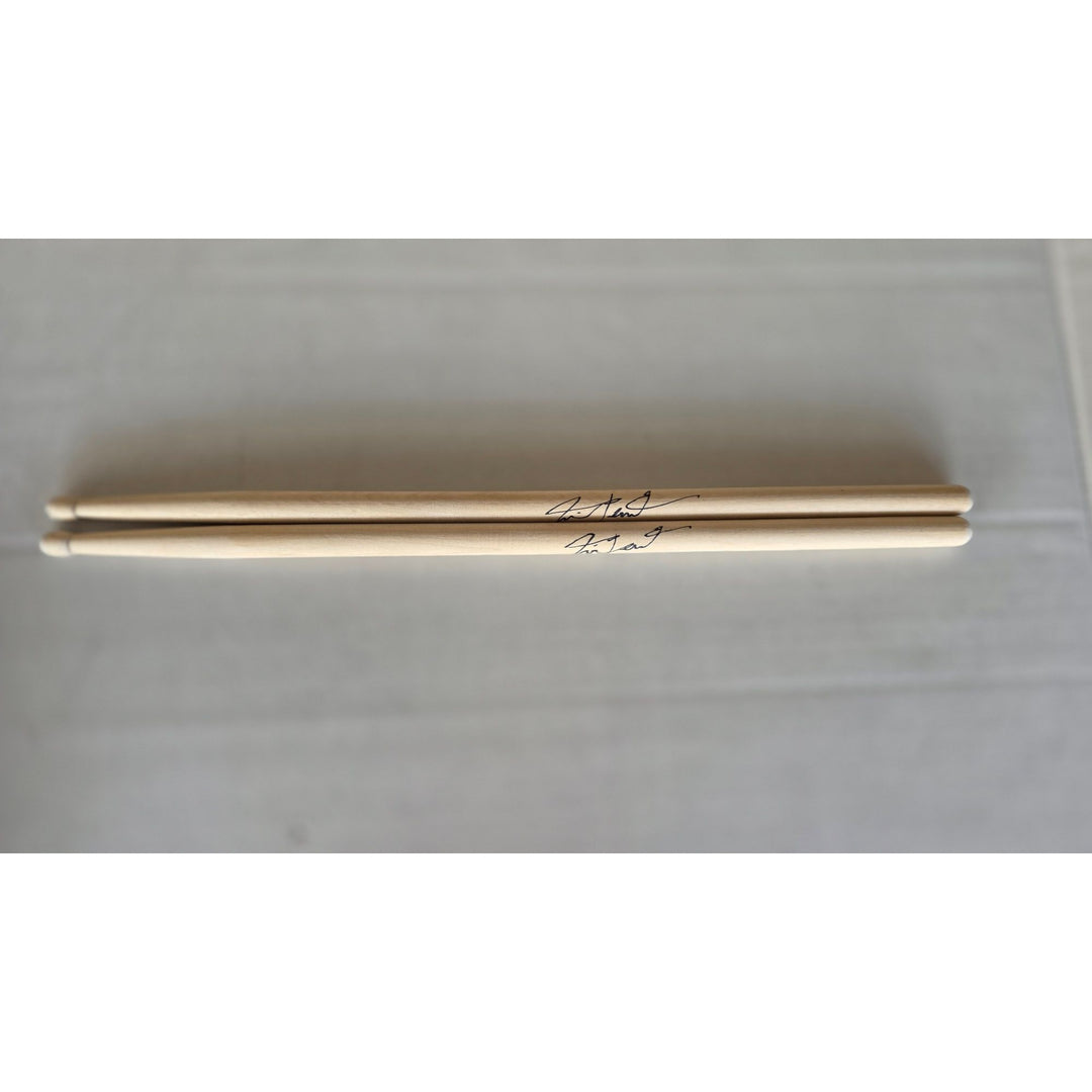 Neil Peart Rush pair of drumsticks signed with proof.