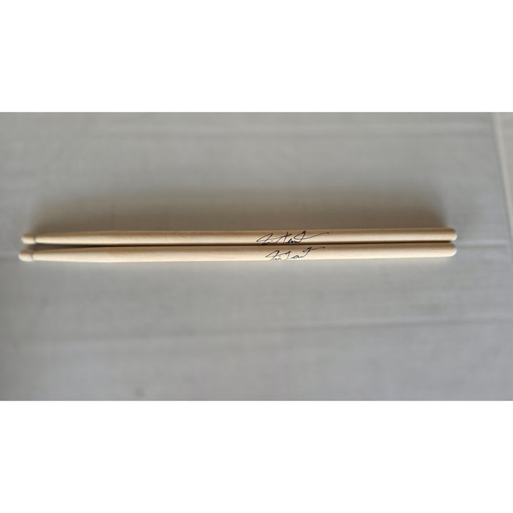 Neil Peart Rush pair of drumsticks signed with proof.