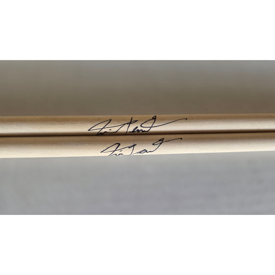 Neil Peart Rush pair of drumsticks signed with proof.