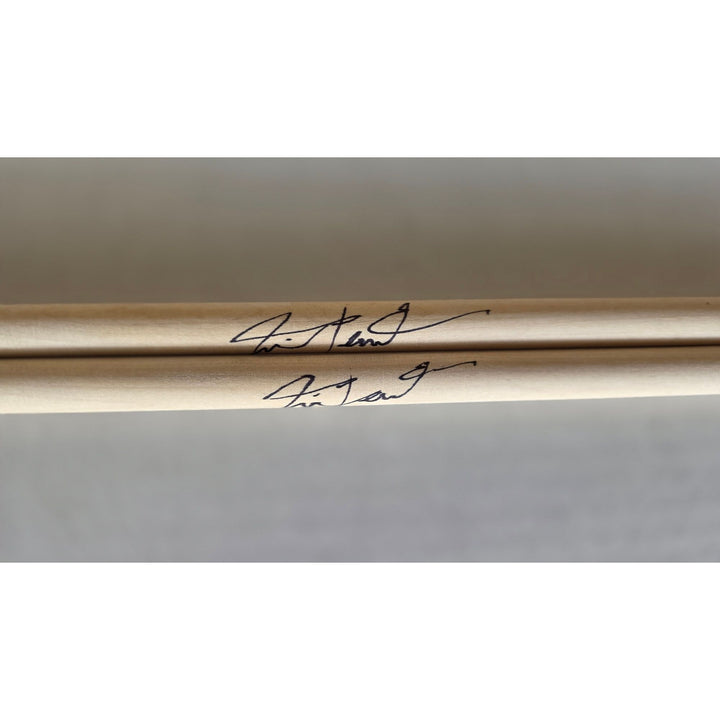 Neil Peart Rush pair of drumsticks signed with proof.