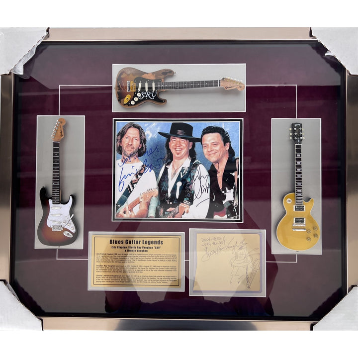 Stevie Ray and Jimmy Vaughan with Eric Clapton signed and framed with proof.