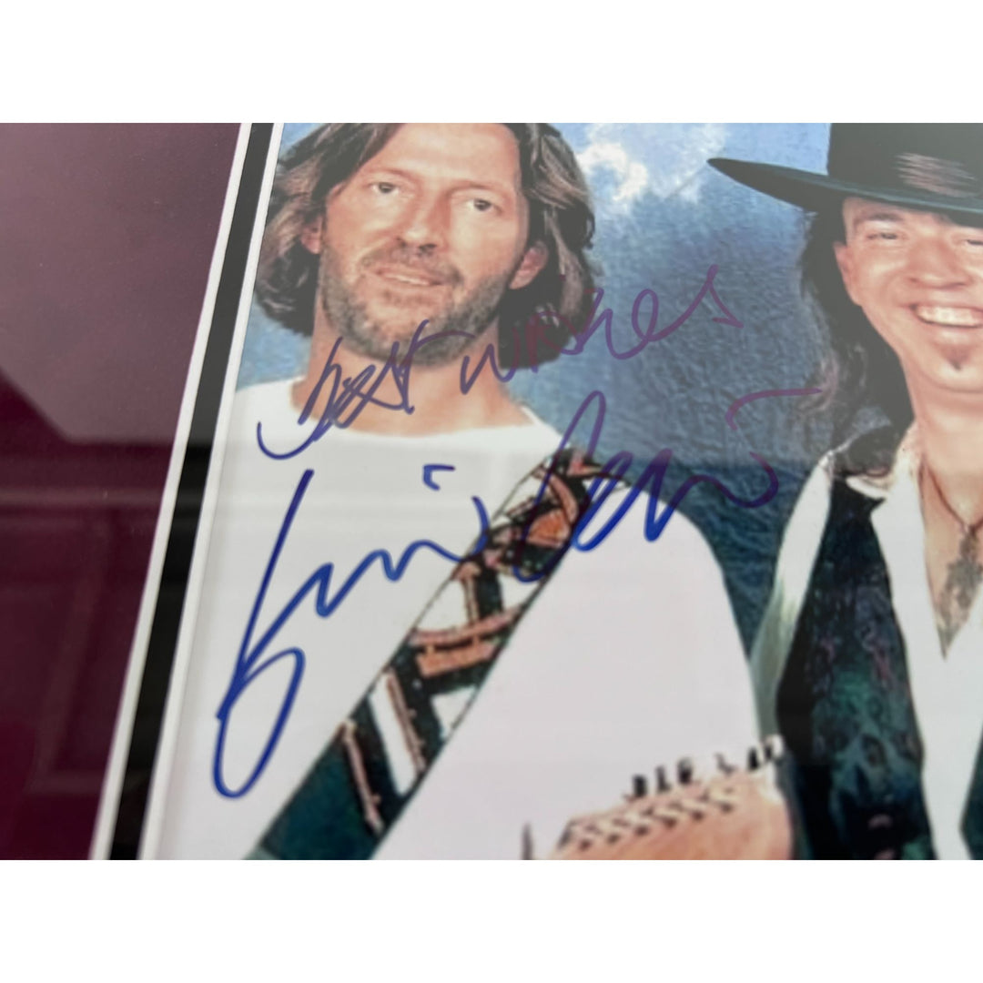 Stevie Ray and Jimmy Vaughan with Eric Clapton signed and framed with proof.