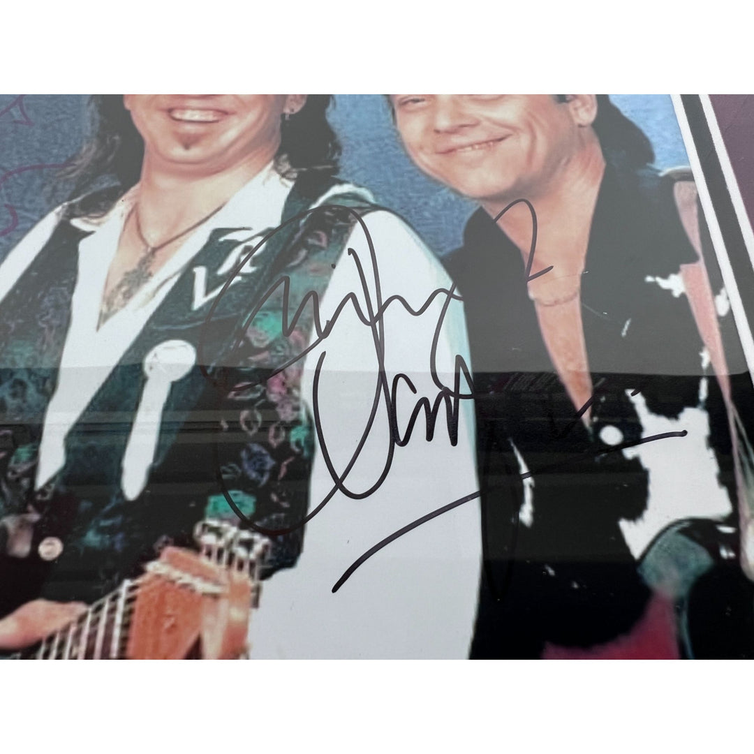 Stevie Ray and Jimmy Vaughan with Eric Clapton signed and framed with proof.