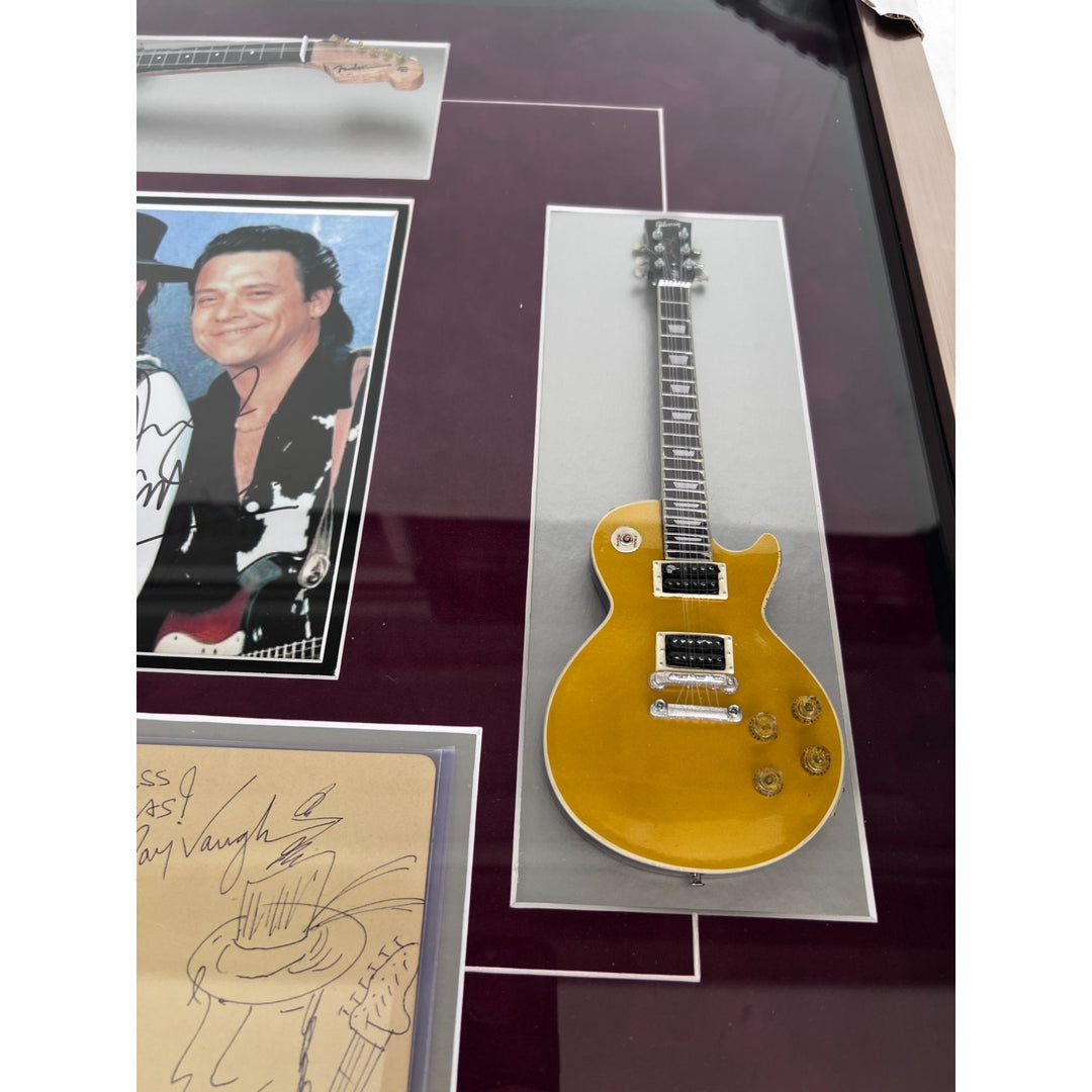 Stevie Ray and Jimmy Vaughan with Eric Clapton signed and framed with proof.