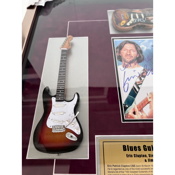 Stevie Ray and Jimmy Vaughan with Eric Clapton signed and framed with proof.