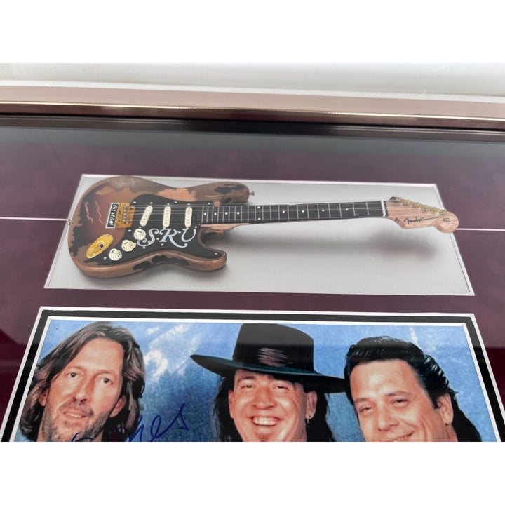 Stevie Ray and Jimmy Vaughan with Eric Clapton signed and framed with proof.