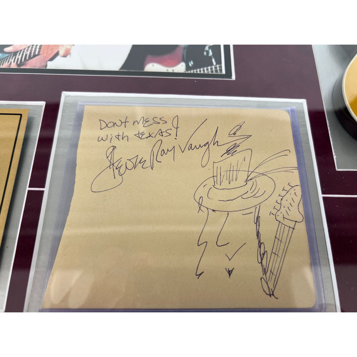 Stevie Ray and Jimmy Vaughan with Eric Clapton signed and framed with proof.