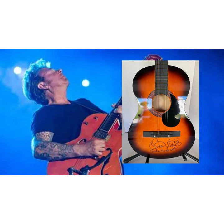 Musician playing a red guitar on stage with blue lights; inset of a sunburst acoustic guitar.