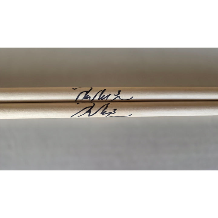 Taylor Hawkins Foo Fighters pair of drumsticks signed with proof.