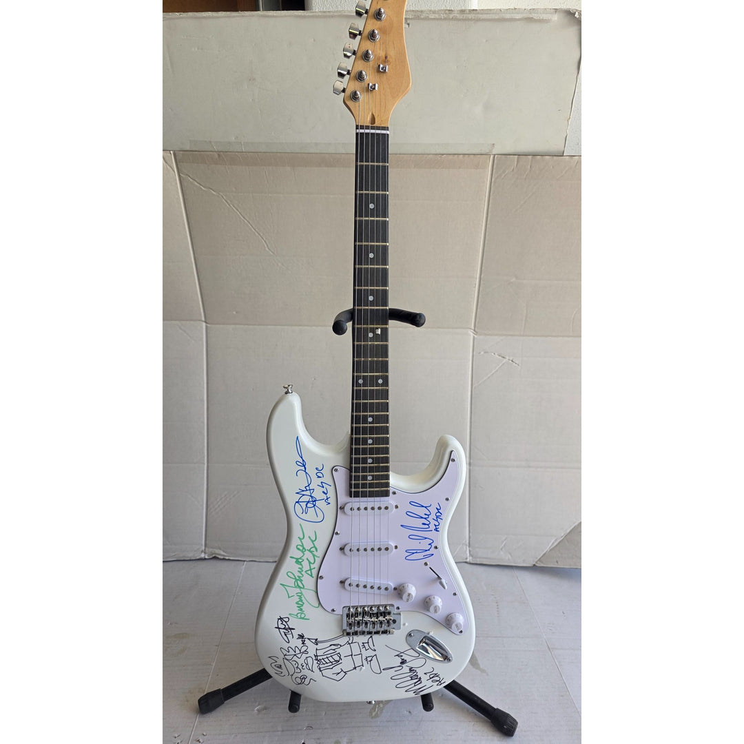 Angus & Malcolm Young, Brian Johnston, Phil Rudd, Cliff Williams AC/DC Fender Stratocaster electric guitar signed with proof.