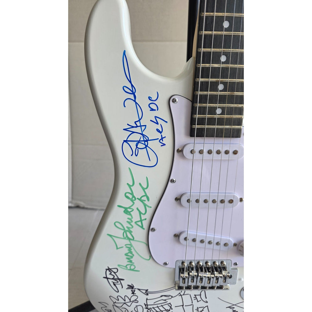 Angus & Malcolm Young, Brian Johnston, Phil Rudd, Cliff Williams AC/DC Fender Stratocaster electric guitar signed with proof.