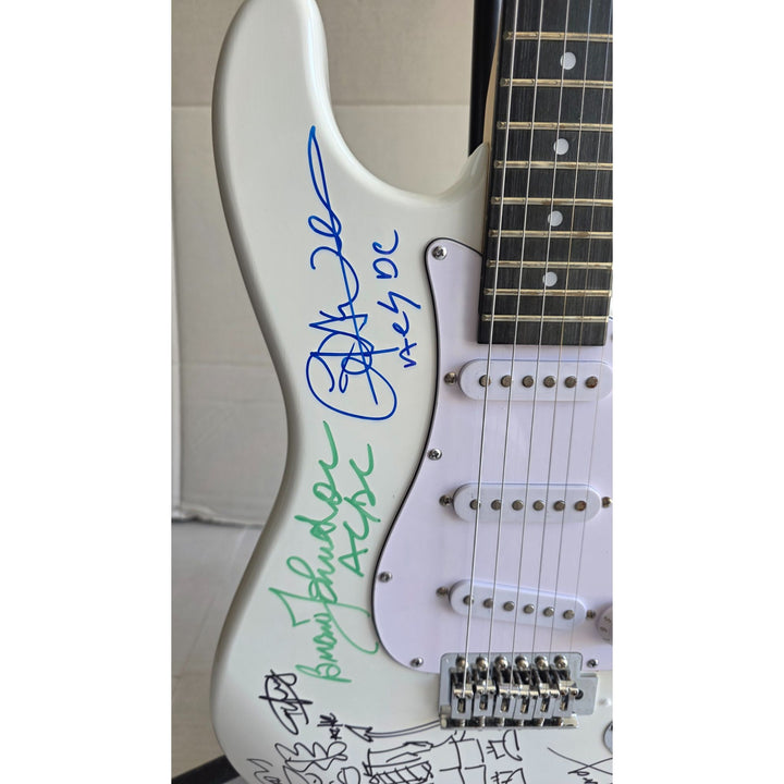 Angus & Malcolm Young, Brian Johnston, Phil Rudd, Cliff Williams AC/DC Fender Stratocaster electric guitar signed with proof.