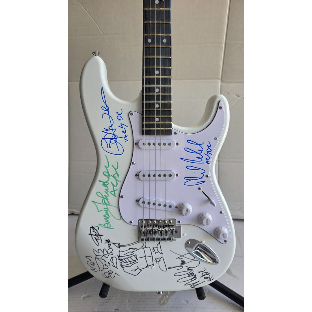 Angus & Malcolm Young, Brian Johnston, Phil Rudd, Cliff Williams AC/DC Fender Stratocaster electric guitar signed with proof.