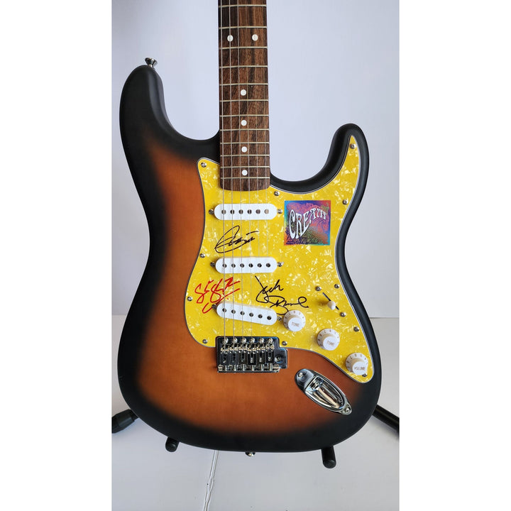 Cream, Eric Clapton, Ginger Baker, Jack Bruce, authentic Fender Stratocaster electric guitar signed with proof