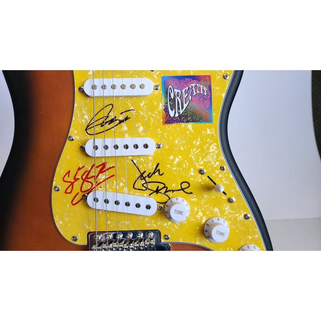 Cream, Eric Clapton, Ginger Baker, Jack Bruce, authentic Fender Stratocaster electric guitar signed with proof