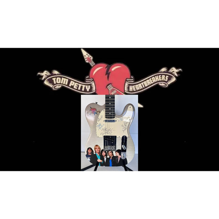 Tom Petty (with sketch) and The Heartbreakers, Ron Blair, Benmont Tench, Scott Thurston, and Mike Campbell full size electric guitar signed.