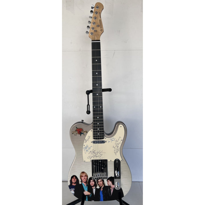 Tom Petty (with sketch) and The Heartbreakers, Ron Blair, Benmont Tench, Scott Thurston, and Mike Campbell full size electric guitar signed.