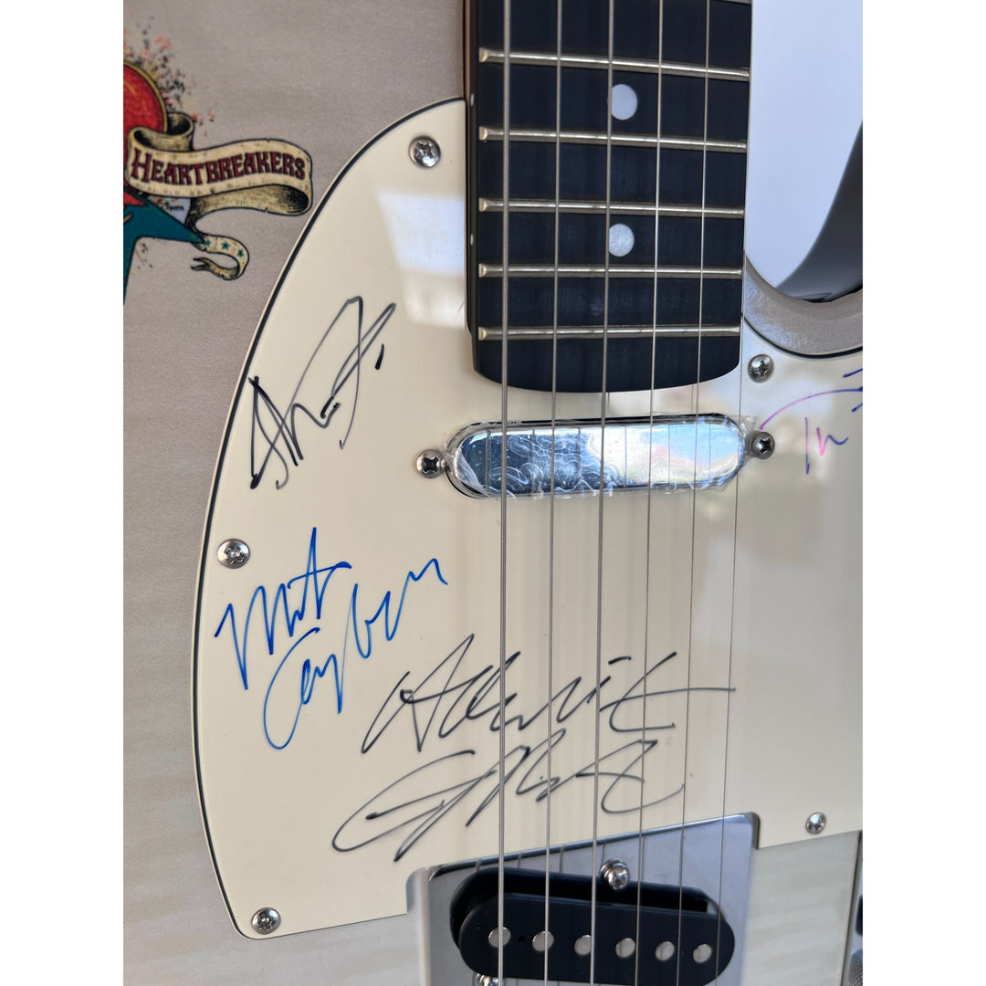 Tom Petty (with sketch) and The Heartbreakers, Ron Blair, Benmont Tench, Scott Thurston, and Mike Campbell full size electric guitar signed.