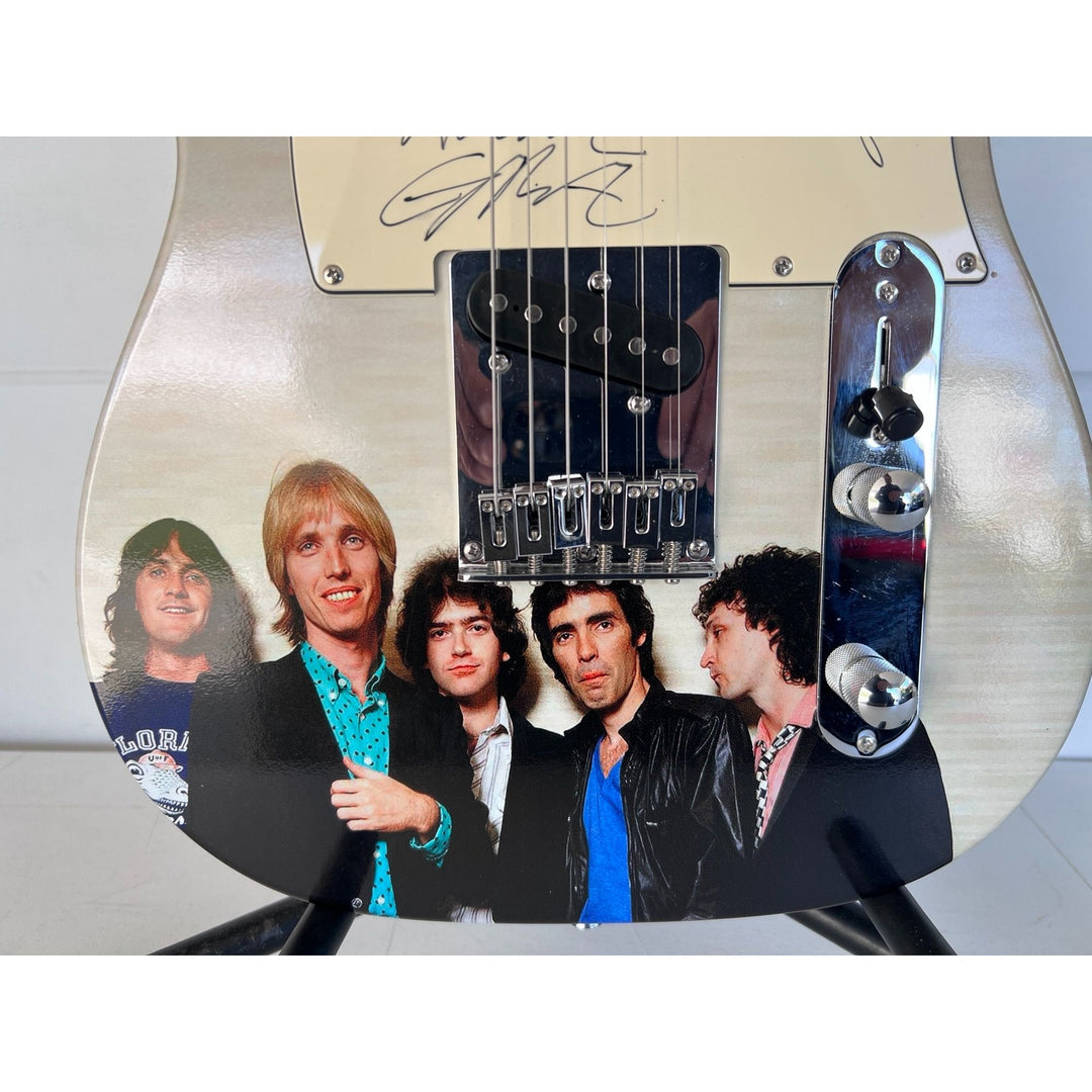 Tom Petty (with sketch) and The Heartbreakers, Ron Blair, Benmont Tench, Scott Thurston, and Mike Campbell full size electric guitar signed.