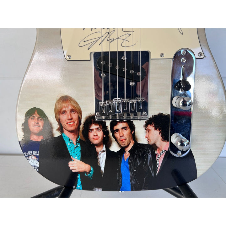 Tom Petty (with sketch) and The Heartbreakers, Ron Blair, Benmont Tench, Scott Thurston, and Mike Campbell full size electric guitar signed.