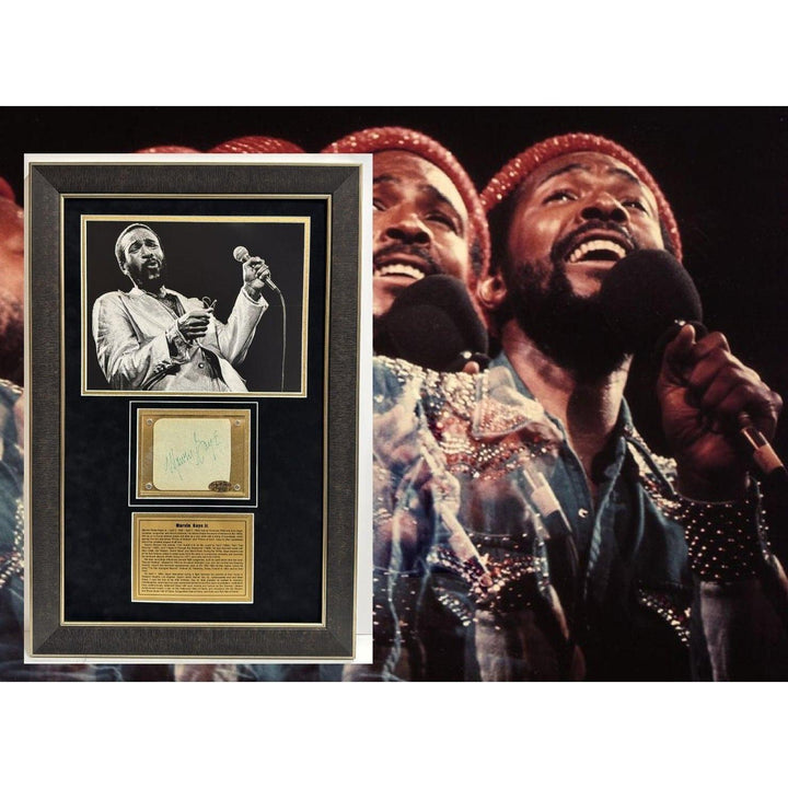 A singer holding a microphone, with a framed photo and plaque, wearing a colorful outfit.