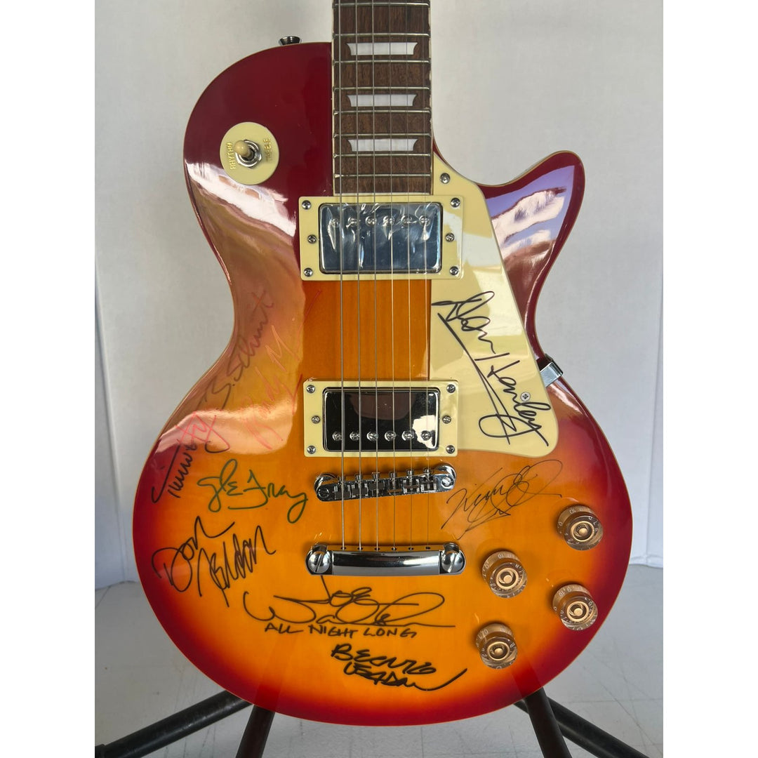 Bernie Leadon, Glenn Frey, Don Henley, Joe Walsh, Don Felder, Randy Meisner Timothy B. Schmit The Eagles Cherry Les Paul guitar signed.