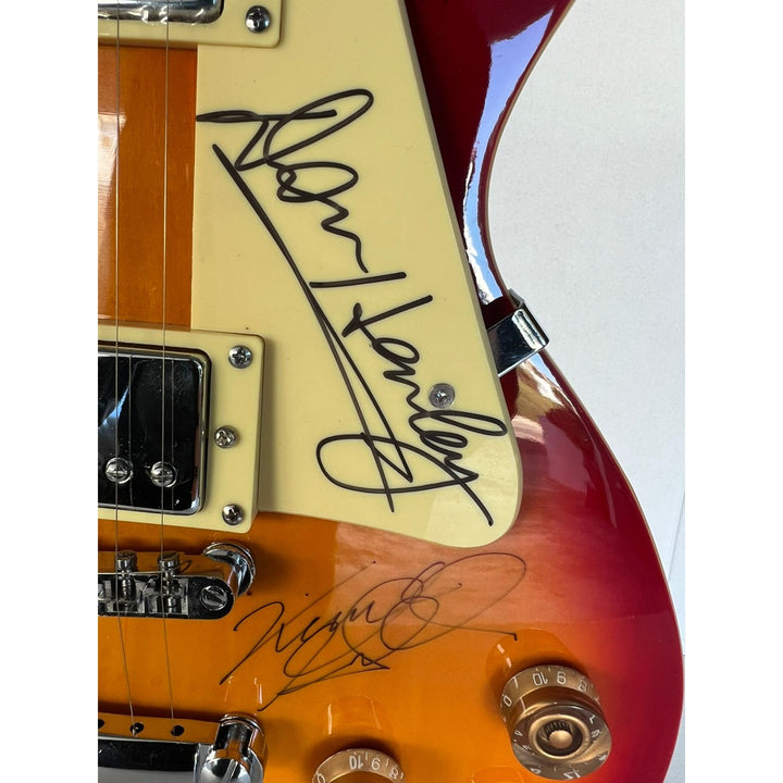 Bernie Leadon, Glenn Frey, Don Henley, Joe Walsh, Don Felder, Randy Meisner Timothy B. Schmit The Eagles Cherry Les Paul guitar signed.