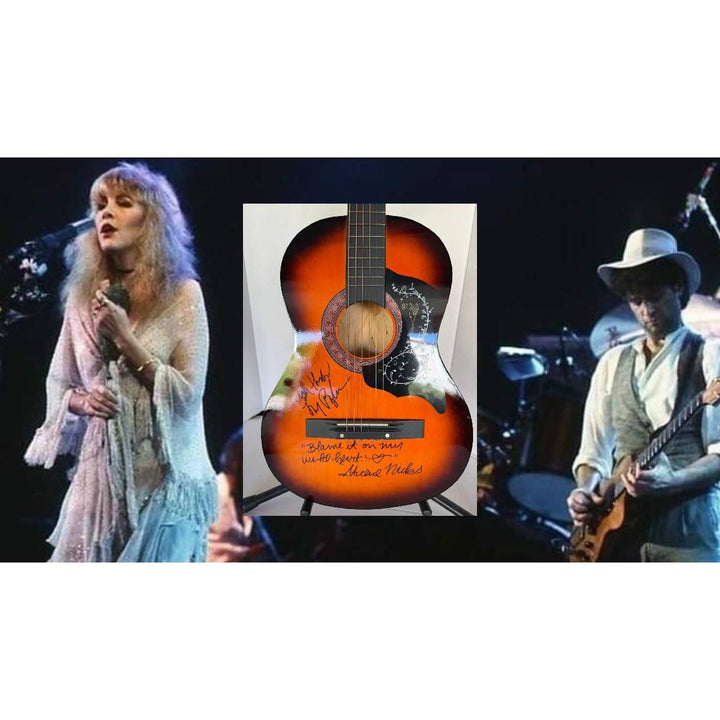 Singer and guitarist performing on stage, with a signed sunburst acoustic guitar in the center.